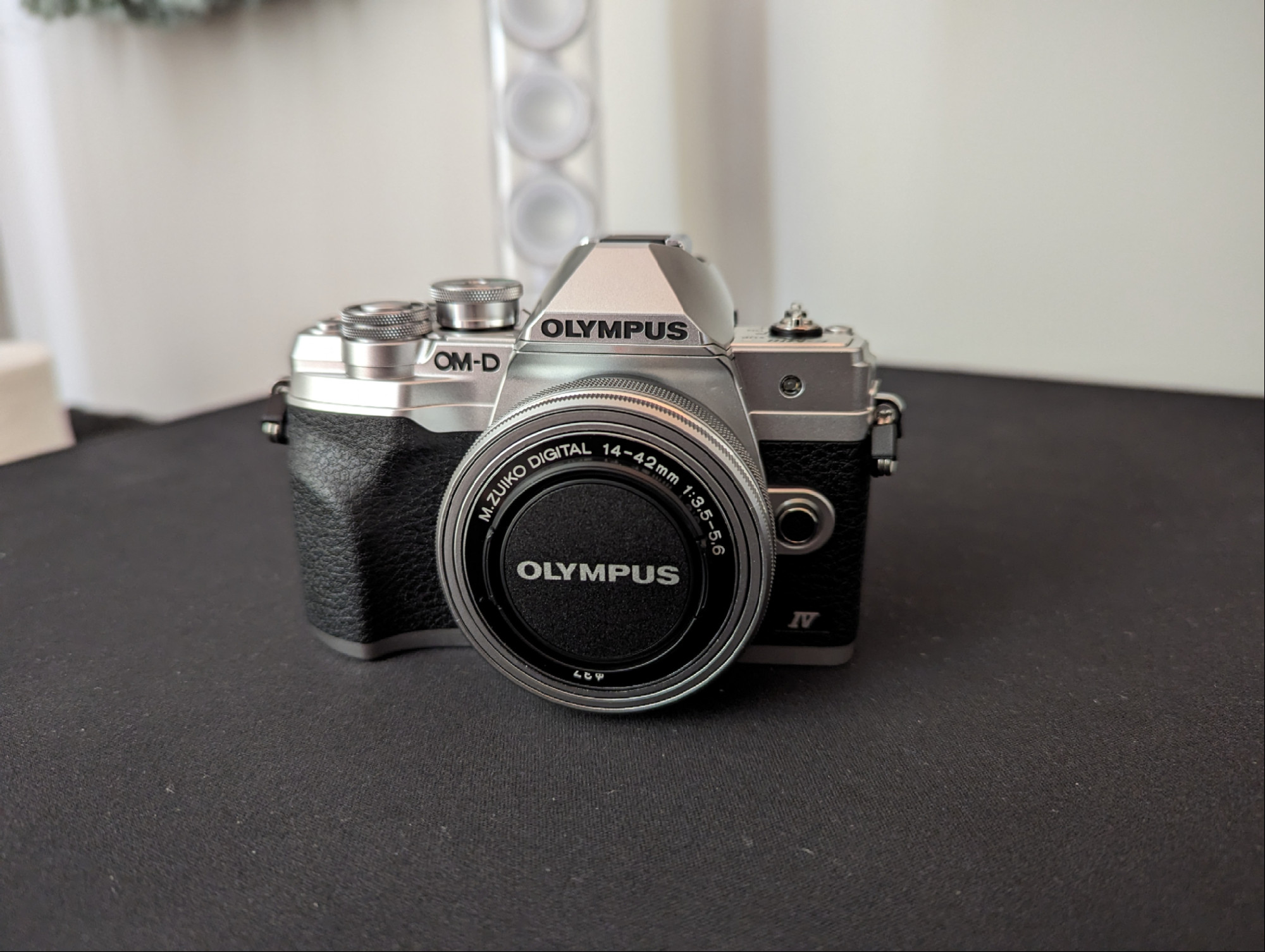 Olympus OM-D E-M10 Mark IV Mirrorless camera Sitting on a black desk