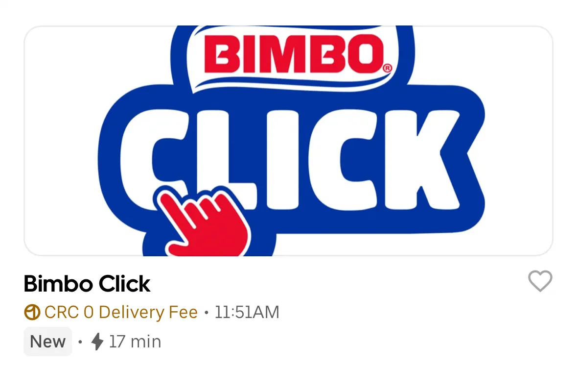 Screenshot of an Uber Eats store listing titled "Bimbo Click." The banner features the red Bimbo logo above a large, bold "CLICK" in white and blue, being selected by a red hand cursor. Below the banner, text indicates "CRC 0 Delivery Fee," a "New" status badge, and an estimated delivery time of 17 minutes.